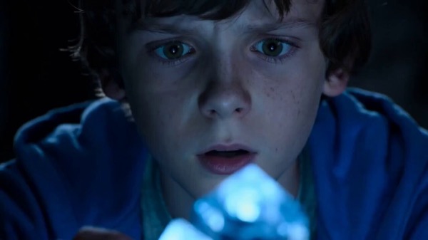 Boy Touches Glowing Crystal in Cave